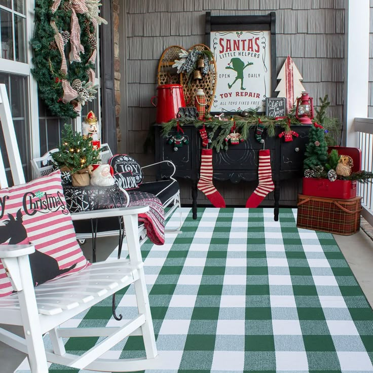 a porch decorated for christmas with holiday decorations