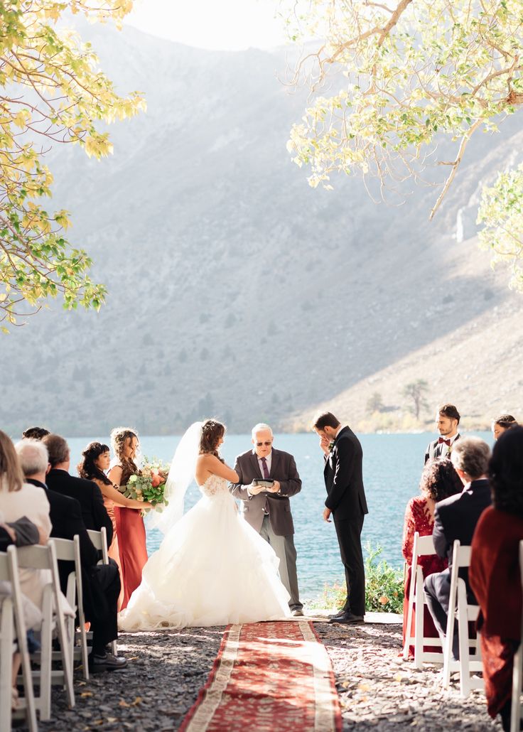 a bride and groom standing at the end of their wedding ceremony