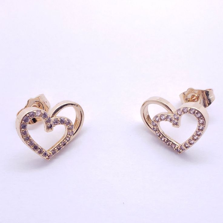 Small with crystals, this small heart holds a design ready to show how big of a heart you have; the design is three dimensional and shows a heart extending to the right. The gold color pops out and brings together the effect. Details Laminated gold 3d heart Clear crystals Earring Gold Heart Earrings With Rhinestones For Valentine's Day, Gold Heart-shaped Earrings With Rhinestones, Gold Rhinestone Heart Earrings, Valentine's Day Gold Rhinestone Jewelry, Valentine's Day Gold Jewelry With Sparkling Stones, Double Heart Cubic Zirconia Earrings For Gift, Party Double Heart Cubic Zirconia Earrings, Heart-shaped Gold Cubic Zirconia Earrings, Gold Double Heart Cubic Zirconia Earrings