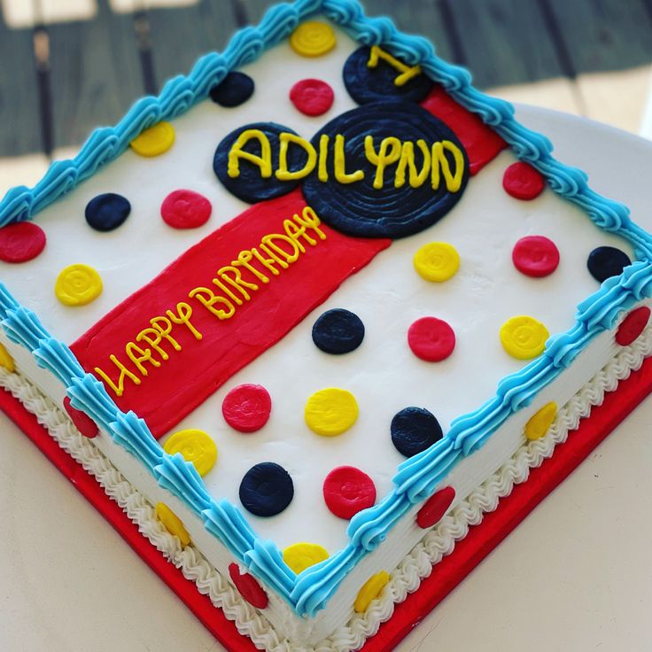 a birthday cake is decorated with polka dots