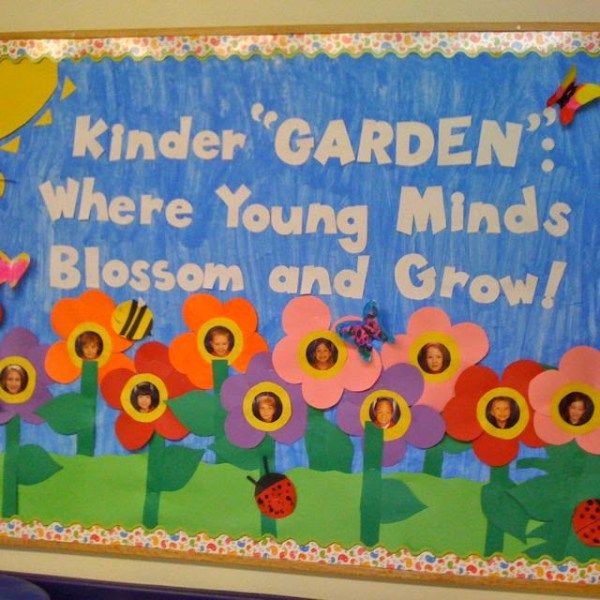 a bulletin board with flowers on it and the words kinder garden where young minds blossom and grow