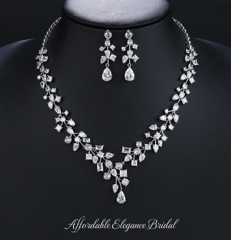 Beautiful CZ Bridal and Special Occasion Jewelry Set Add a glamorous touch to your wedding day or special occasion with this sparkling 3A quality CZ necklace and earring set. This rhodium silver plated jewelry set glistens with brilliant multi-cut CZ crystals. The unique vine design will add a romantic touch to your special day. Size: The necklace is about 17" long and the pierced earrings are about 1.5" long. Color: Silver/ Clear. Style: ne10990. Please allow 3 weeks for delivery. Shipping Policy . Return Policy Winter Wedding Accessories, Gold Bridesmaid Jewelry, Diamond Jewelry Set, Veil Accessories, Bridesmaid Pearls, Special Occasion Jewelry, Bridal Jewelry Set, Pearl Jewelry Wedding, Gold Headband