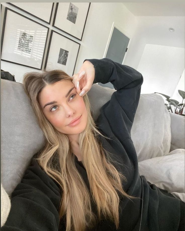 a woman sitting on top of a couch in a living room