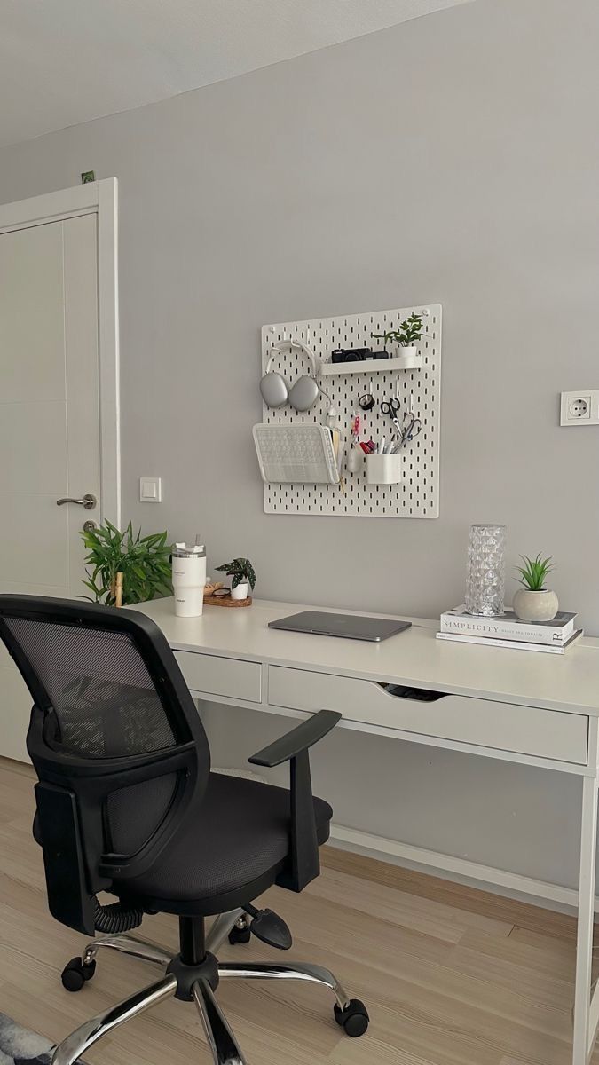 a white desk with a black chair in front of it