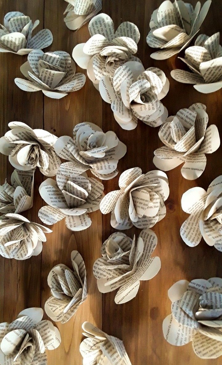 paper flowers are arranged on a wooden table