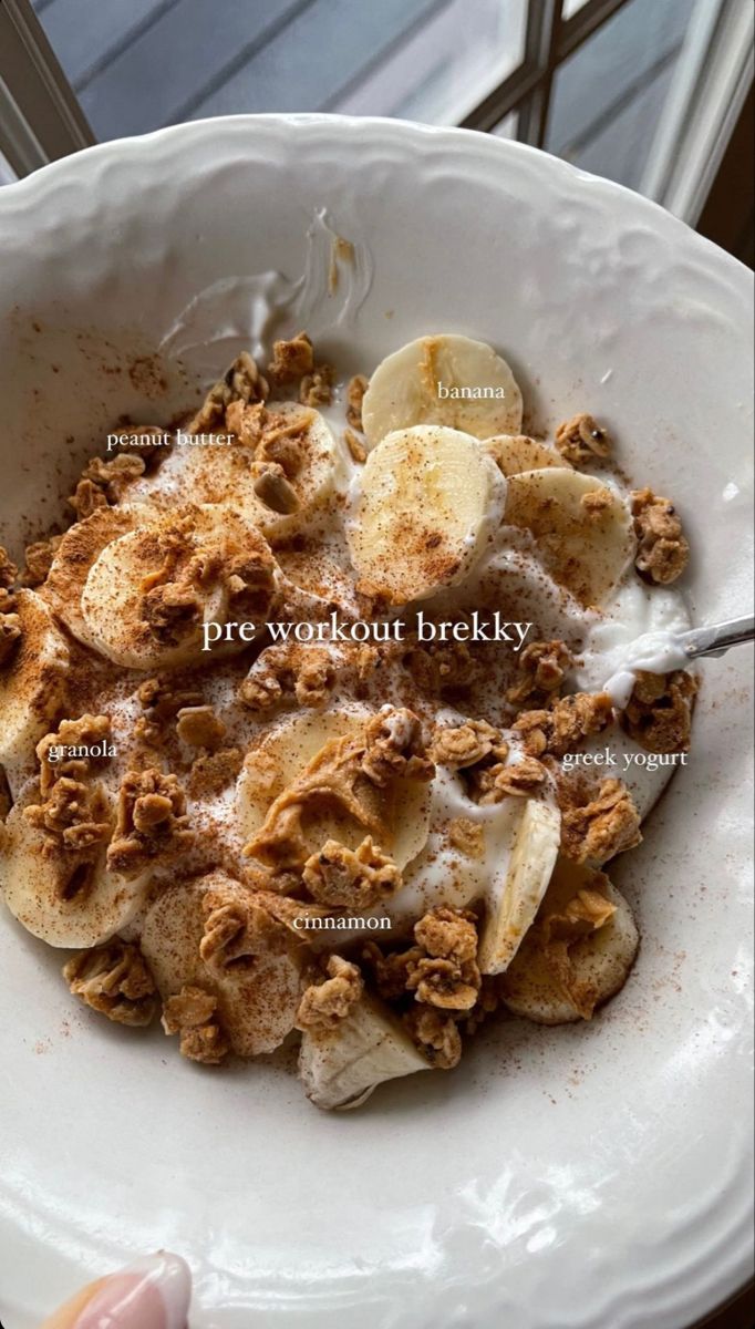 a white bowl filled with cereal and bananas