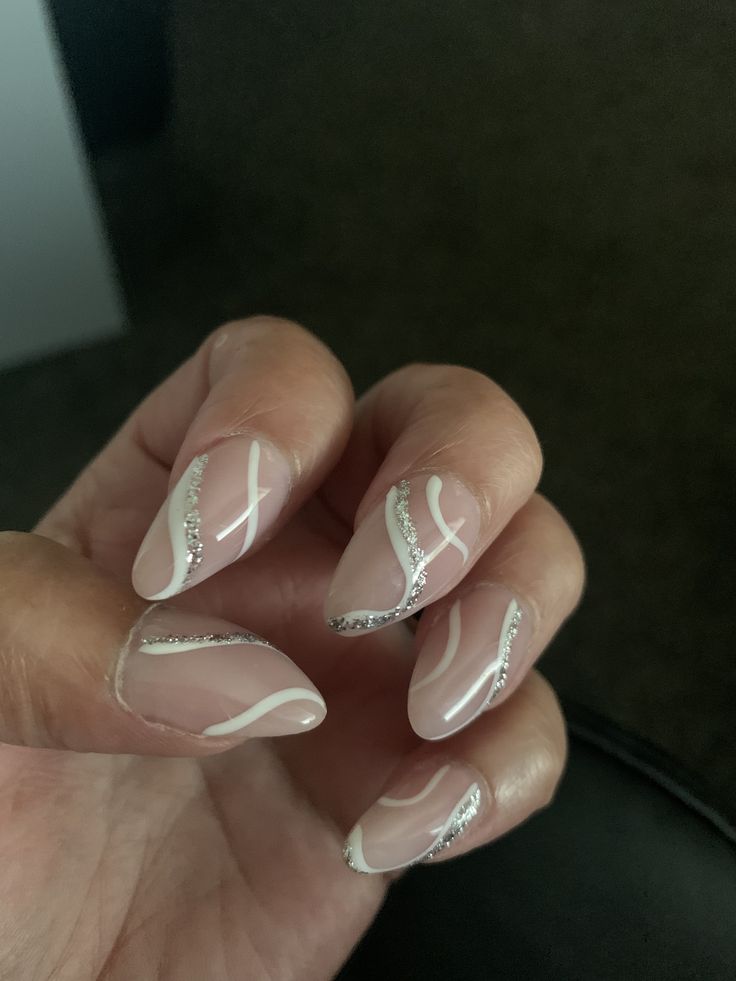 Hoco Nails White And Silver, White And Silver Acrylic Nails Prom, Silver Nails Ideas Almond, White Silver Swirl Nails, White And Glitter Swirl Nails, White And Silver Nails Acrylic Short, Neutral Prom Nails Acrylic, Homecoming Nails Acrylic Almond, Silver Pattern Nails