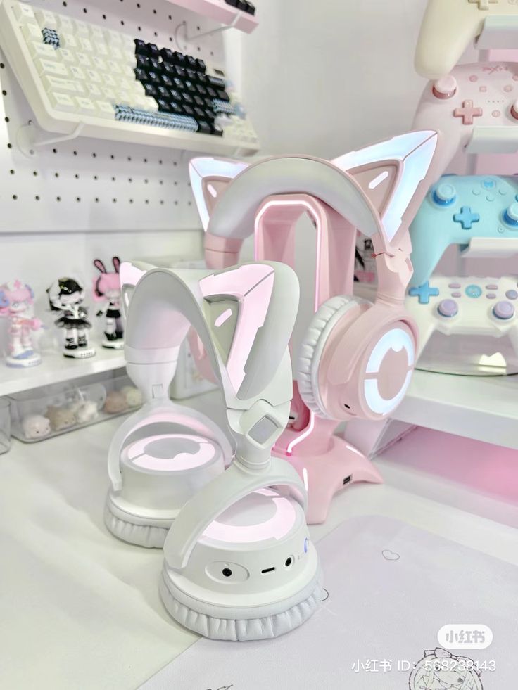 a pair of pink and white headphones sitting on top of a counter in a store