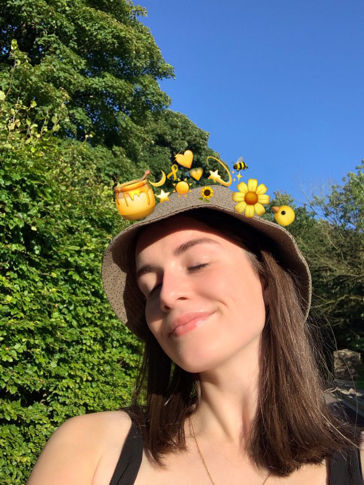 a woman wearing a hat with sunflowers on it