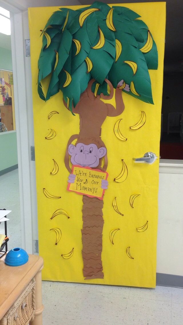 a door decorated to look like a banana tree with a monkey on it's trunk