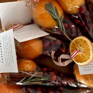 oranges wrapped in cellophane and tied with ribbon, sitting next to each other