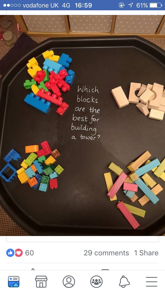 a black tray topped with lots of legos on top of a wooden floor next to a sign that says which blocks are best for building?