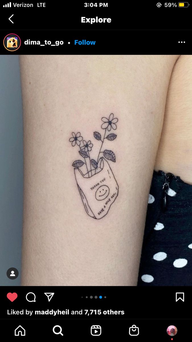 a woman's arm with a small flower vase tattoo on the left side of her arm