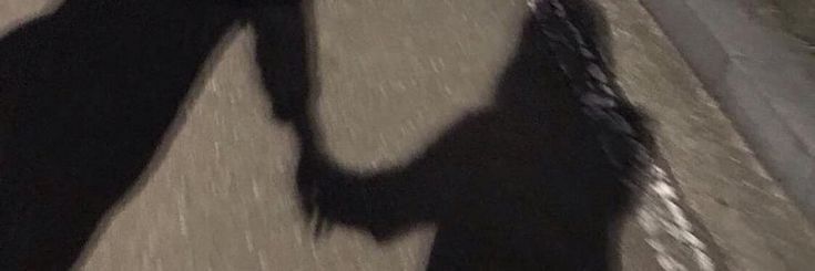 the shadow of two people holding hands