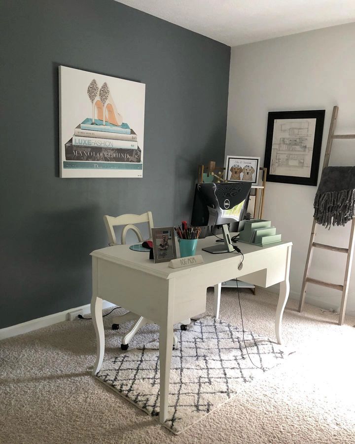 a white desk sitting on top of a carpeted floor