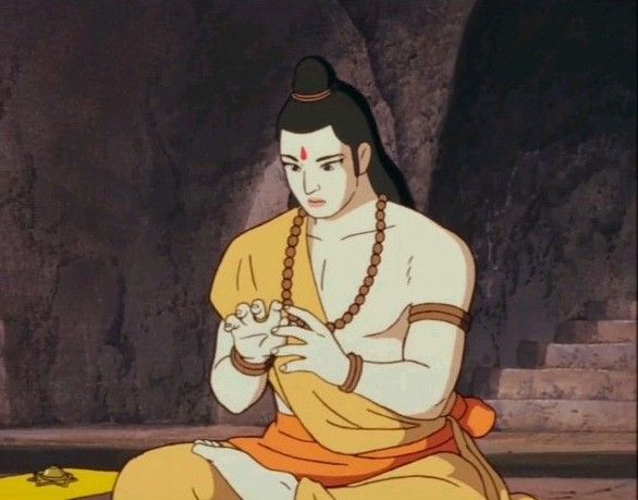 a man sitting on top of a yellow floor next to a stone wall in front of a cave