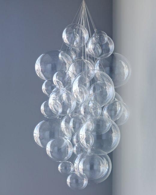 a chandelier made out of clear bubbles hangs from a ceiling in a room