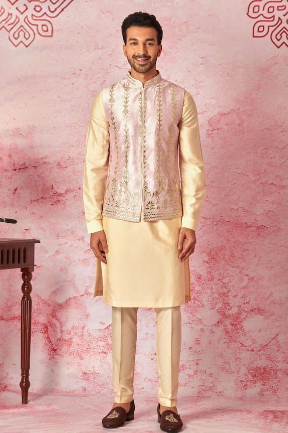 Pink raw silk bundi with golden leather patch strips embroidery in vertical lines, horses, leaves, and geometric design motifs. Paired with an inner kurta and pyjama. - Aza Fashions Festive Bandhgala With Gota Work In Straight Kurta Style, Festive Bandhgala With Gota Work, Chanderi Nehru Jacket For Designer Wear And Festive, Festive Chanderi Nehru Jacket For Designer Wear, Designer Chanderi Kurta For Eid, Designer Chanderi Kurta For Festive Occasions, Festive Designer Chanderi Kurta, Designer Chanderi Sherwani With Resham Embroidery, Designer Chanderi Kurta For Festivals