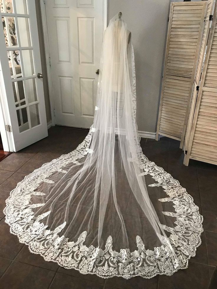 a wedding veil on the floor in front of a door