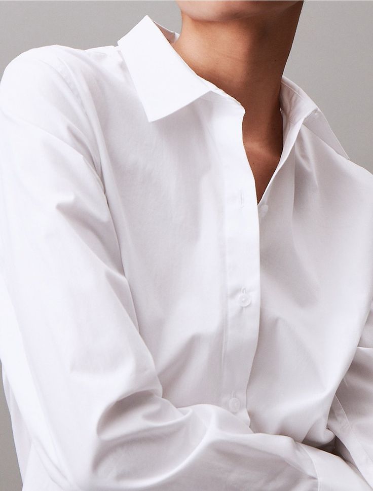 Defined with crisp tailoring and timeless styling, this button-down shirt captures a concise, elevated look. Cut in a classic fit and detailed with barrel cuffs. Crafted from cotton stretch poplin for a lightweight feel with a refined touch.  Material: 96% Cotton, 4% Elastane. Poplin Shirt, Barrel, Calvin Klein, Button Down Shirt, Pure Products