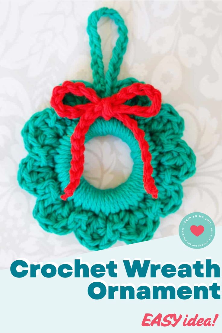 the crochet wreath ornament is made from yarn and has a red bow on it