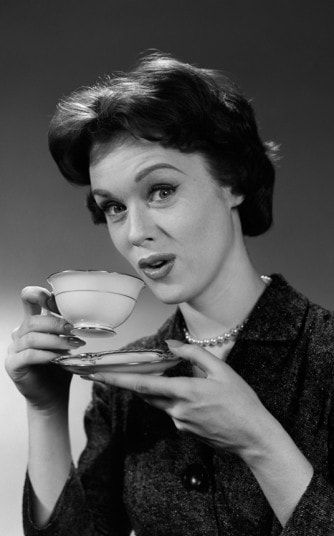 a woman holding a tea cup and saucer in her hand with the caption you know that