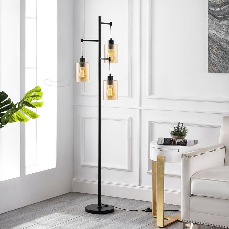 a living room with a white chair and a black floor lamp in the corner next to a potted plant