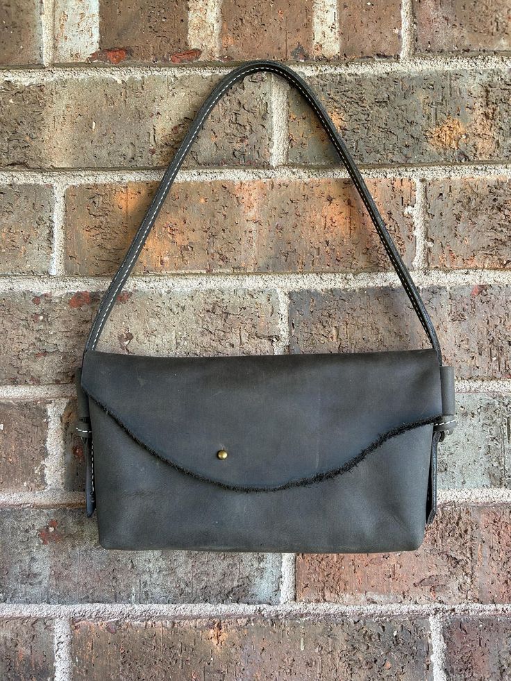 This handmade bag is a soft leather that feels wonderful and has a bit of a distressed look to add character. The interior is open and simple. Would easily fit phone, checkbooks, cash, keys, etc. Easy to open and close. Handle is stitched for added durability. Size: approximately 5" tall x 8" wide Message with any other questions. :) Leather Rectangular Clutch For Daily Use, Everyday Satchel Clutch With Magnetic Closure, Classic Clutch With Cell Phone Pocket For Everyday Use, Daily Use Leather Clutch, Daily Use Textured Leather Clutch, Leather Satchel Clutch With Cell Phone Pocket, Everyday Textured Leather Clutch Shoulder Bag, Leather Clutch With Cell Phone Pocket, Rectangular Soft Leather On-the-go Wallets