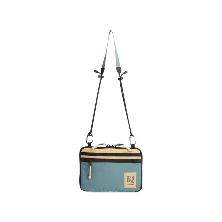 a blue and black bag with straps hanging from it's side on a white background