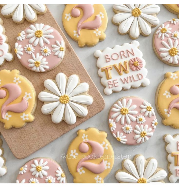 decorated cookies with the words born to be wild on them and daisies next to each other