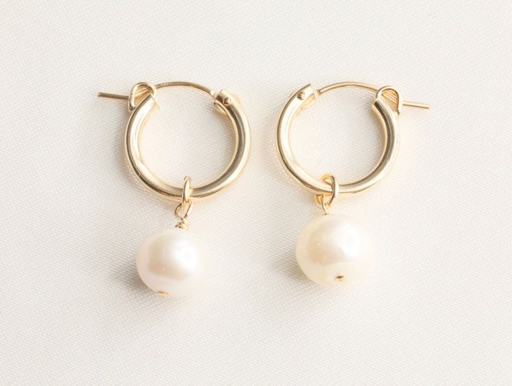 Gold Pearl Earrings / 14k Gold Filled / Bridal Earrings / Wedding Earrings / Dainty Earrings / Dainty Pearl / Pearl Hoops / White Pearl - 8 mm genuine fresh water pearls. - 14k gold filled 13mm flex hoop earrings - Sold as a pair - Tarnish free, hypoallergenic, nickel free and safe for sensitive skin Please note: since our freshwater pearls are all natural, each pearl is individually unique in size, shape, and shade. We try our best to be consistent as possible to give you the best quality. 💰 W White 14k Gold Filled Bridal Earrings As Gift, 14k Gold Filled White Bridal Earrings As Gift, White Dangle Hoop Earrings In Fine Jewelry Style, White 14k Gold Filled Earrings For Weddings, Wedding White 14k Gold Filled Hoop Earrings, White Fine Jewelry Hoop Earrings For Wedding, 14k Gold-filled Dangle Hoop Earrings For Wedding, 14k Gold Filled Dangle Hoop Earrings For Wedding, 14k Gold Filled Wedding Earrings For Pierced Ears