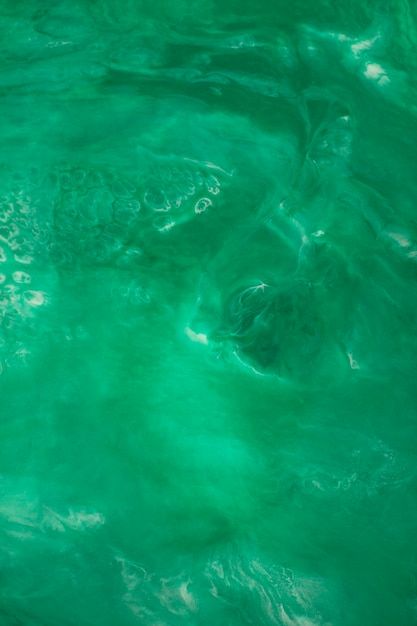 the water is very green and it looks like something out of an alien movie or film