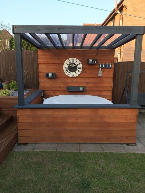 a bed sitting under a wooden pergol with a clock on it's face