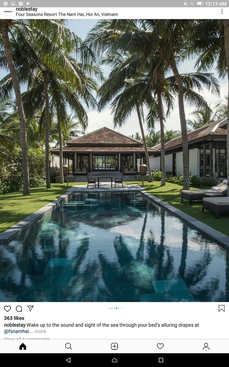 the pool is surrounded by palm trees and lawn chairs, with an open gazebo in the background