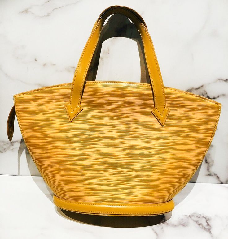 Louis Vuitton Saint Jacques Epi yellow bag in very good condition, with slight wear on the bottom of the bag and one mark on the lining (please see pictures). Approximate Measurements: Size PM, Length 9”, Height 8.5”, Handle Drop 5.5”Made in France. Formal Yellow Shoulder Bag With Top Carry Handle, Luxury Yellow Business Bags, Yellow Business Bags With Gold-tone Hardware, Formal Yellow Bag With Double Handle, Formal Yellow Double Handle Bag, Formal Yellow Double Handle Bags, Classic Yellow Shoulder Bag For Formal Occasions, Formal Yellow Shoulder Bag With Double Handle, Classic Yellow Business Bags