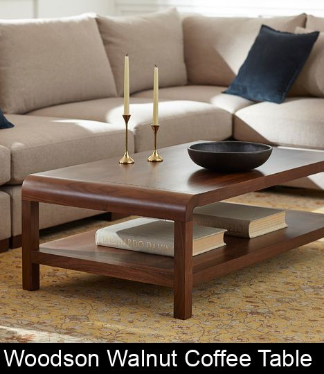 a living room with a couch, coffee table and candlesticks on the end tables