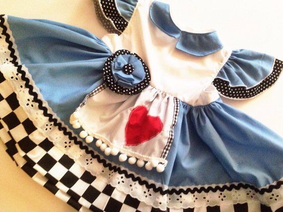 a dress made to look like a doll with a heart on the chest and black and white checkered skirt