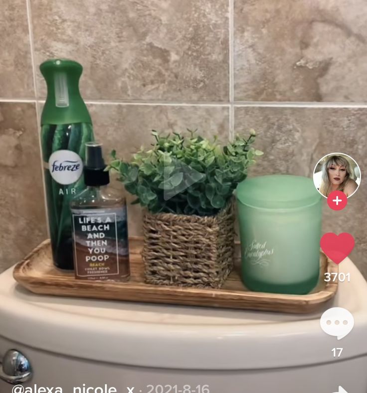 a bathroom sink with plants and personal care products on it