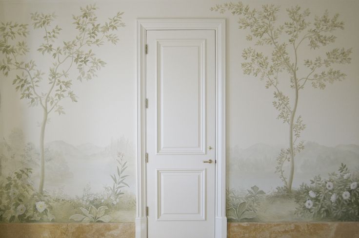 an open door in front of a wall mural