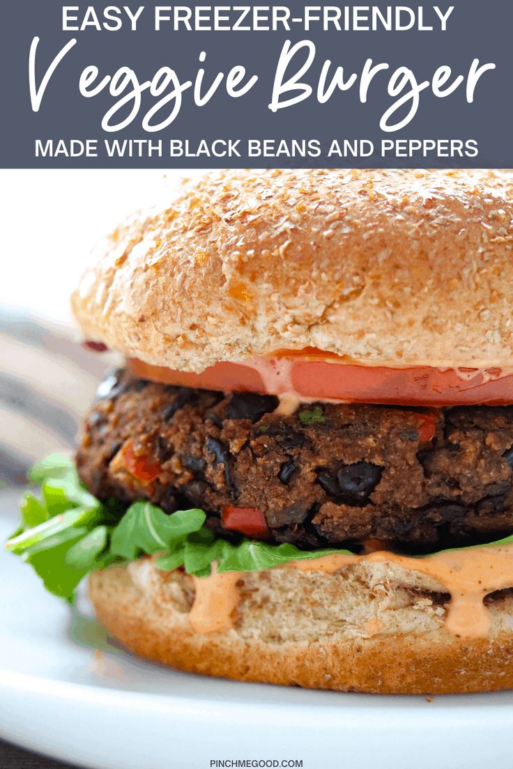 a black bean burger with lettuce and tomato on it is sitting on a white plate