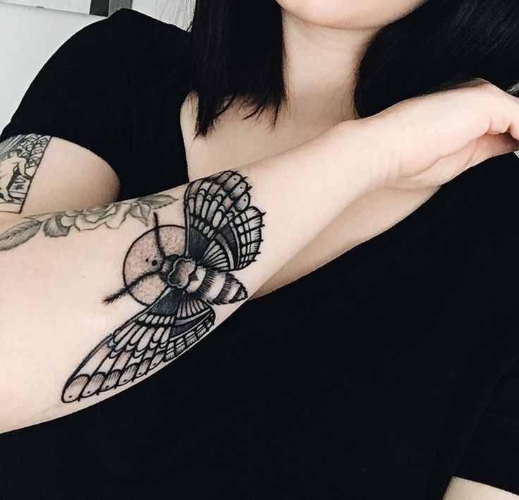 a woman with a tattoo on her arm