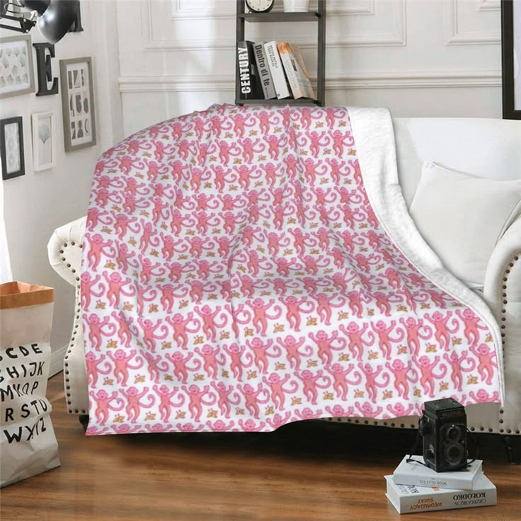 a couch with a pink and white blanket on it