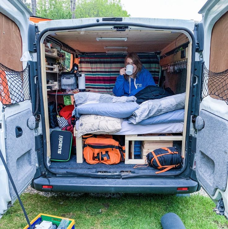 a person sitting in the back of a van