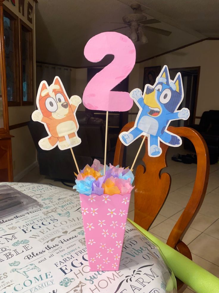 there are two cupcake toppers on the table