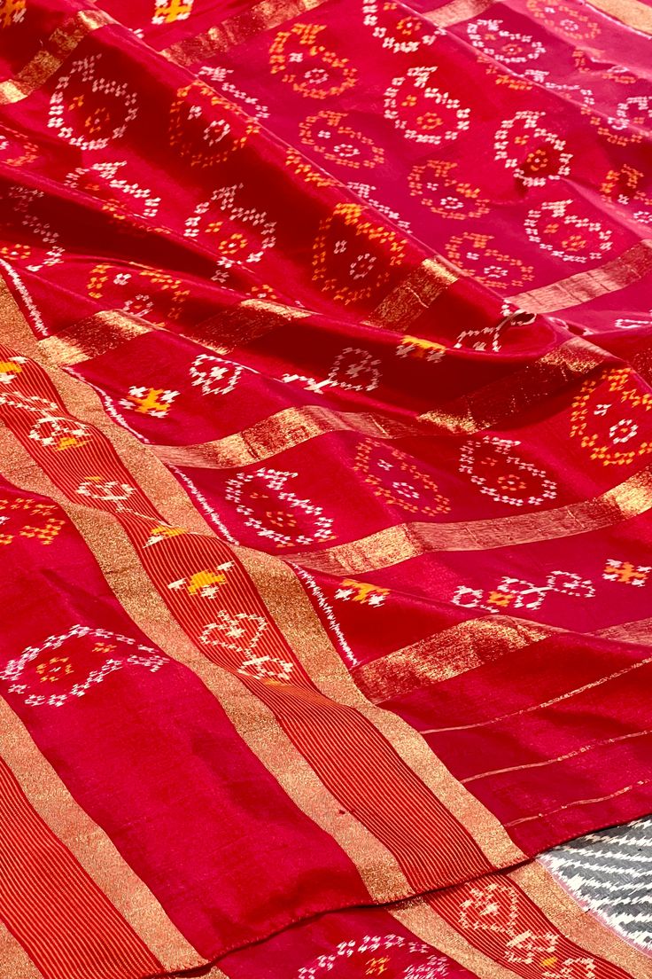 This exquisite pochampally ikkat silk saree is grey color is handwoven. The body is adorned with leheriya pattern while the elaborate broad border on one side is in maroon color with woven paisley motifs while the other side is plain along with gold zari lines. The maroon colored pallu repeats the paisley motifs along with gold zari lines. The blouse is in maroon color with lehriya pattern and decorated border in traditional ikkat designs. Approximate Length 6.5 mtrs (inclusive of blouse length) Red Tussar Silk Saree With Motifs, Red Saree With Woven Motifs, Ceremonial Red Motifs Saree, Red Tussar Silk Pre-draped Saree With Motifs, Red Ikat Print Saree For Puja, Silk Cotton Sarees, Maroon Color, Ikkat Silk Sarees, Blouse Length