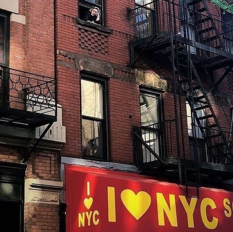 a red sign that says i love nynyc on the side of a building