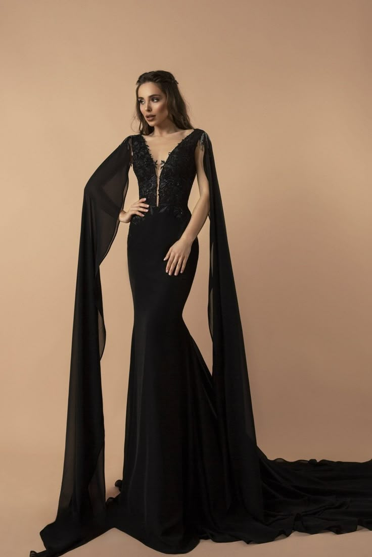 Our "Embroidery Gothic Black Evening Dress with Flowing Sleeves and Plunging Neckline Plus Size" captures the essence of Gothic romance infused with contemporary elegance. This exquisite dress boasts sumptuous black fabric adorned with intricate embroidery, creating a tapestry of dark beauty that adorns your silhouette. The plunging neckline offers a daring glimpse of allure, framed by the soft, flowing sleeves that add an ethereal grace to every movement. Meticulously designed for the plus-size Long Sleeve Black Gown, Elegant Mermaid Dress, Flowing Sleeves, Backless Gown, Mermaid Style Dress, Black Evening Dress, Gothic Wedding Dress, Fashion Gowns, Long Sleeve Gown