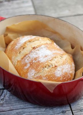 a loaf of bread sitting in a red pan