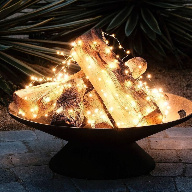 a bowl filled with logs covered in fairy lights