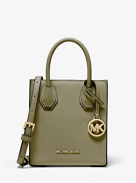 Our scaled-down Mercer crossbody bag will enable you to travel light and while staying stylish. Made from pebbled leather with smooth accents this handbag features structured top handles and an adjustable shoulder strap for added versatility. We love how it will safely hold just the essentials. Michael Kors Travel Bags In Pebbled Leather, Michael Kors Pebbled Leather Travel Bag, Michael Kors Leather Satchel With Top Carry Handle, Michael Kors Textured Leather Satchel For Everyday Use, Modern Satchel By Michael Kors, Modern Michael Kors Satchel For Travel, Modern Michael Kors Travel Satchel, Modern Michael Kors Shoulder Bag With Top Carry Handle, Michael Kors Crossbody Satchel With Top Carry Handle